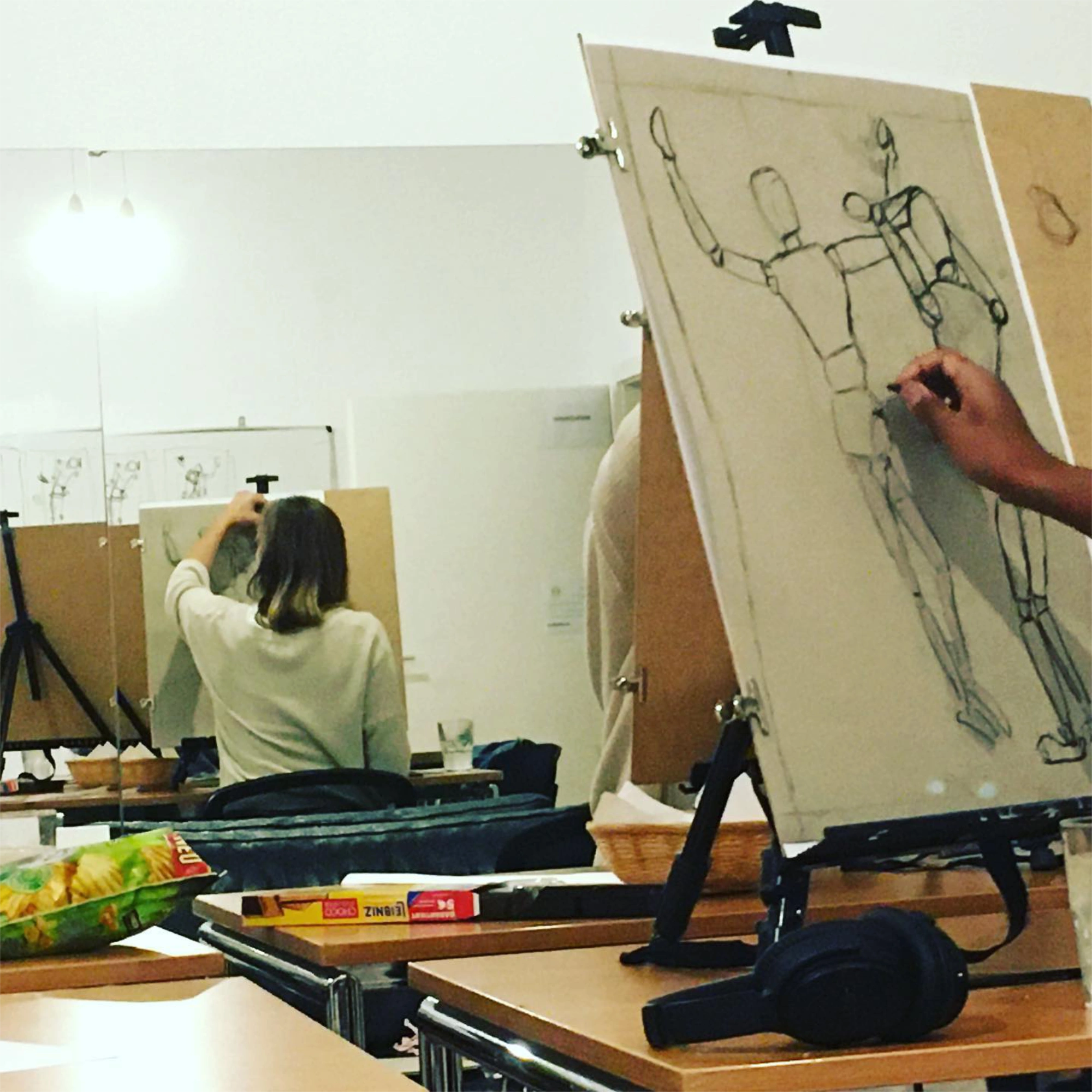 Drawing students working at easels in a studio session