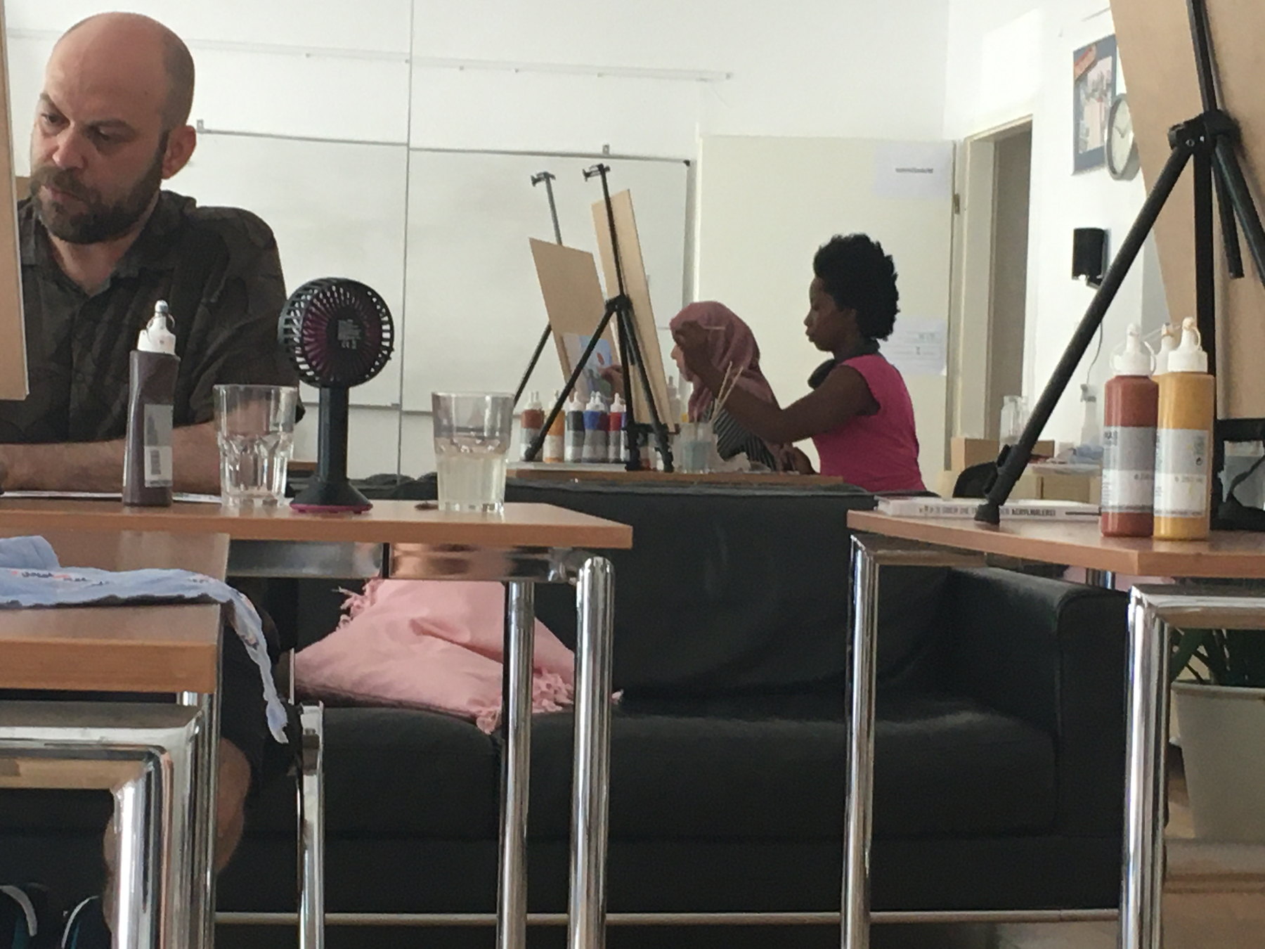Painting class with students, easels and acrylic materials