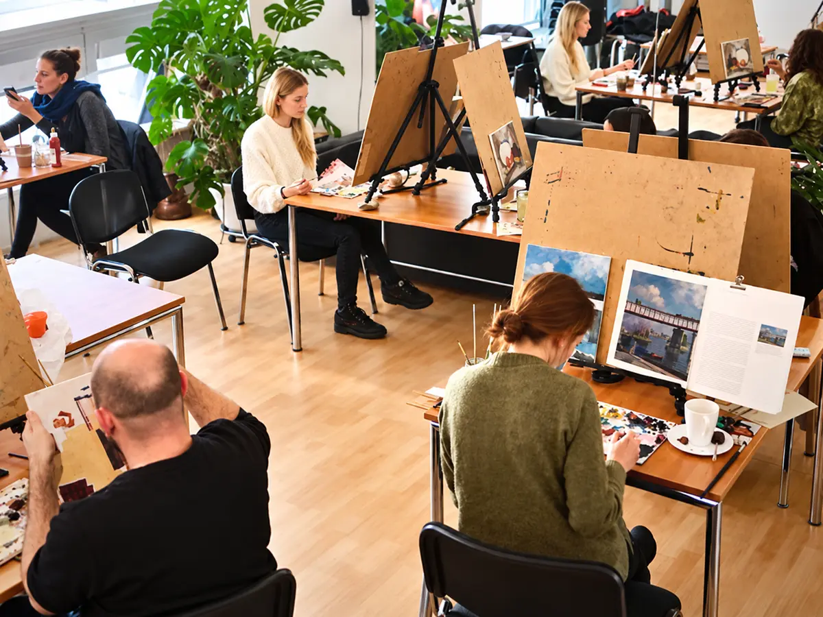 Adults painting together in a small-group workshop in Berlin