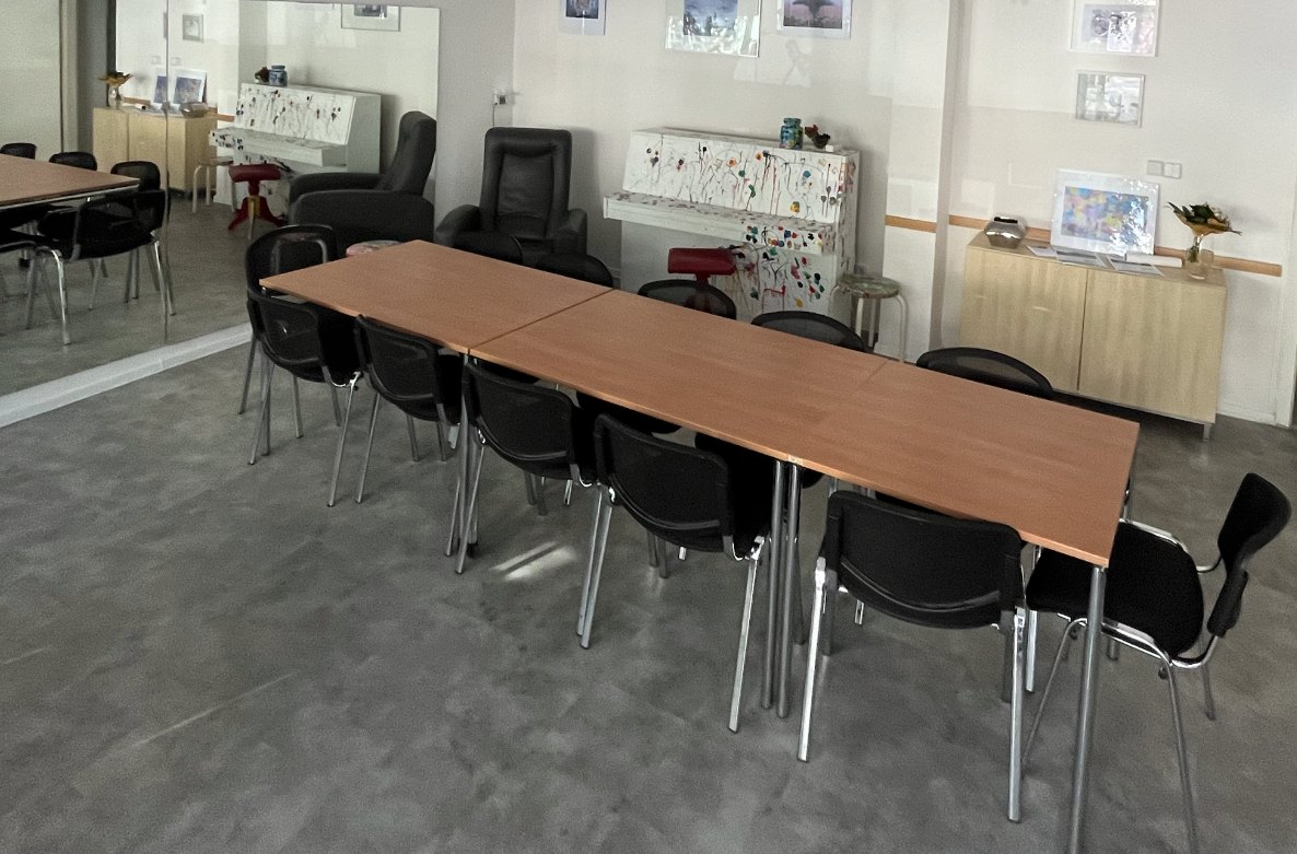 Bright classroom studio setup with tables and easels